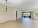 Spacious living room featuring tile floors, neutral walls, and sliding glass doors leading to a patio at 9429 Discovery Ter # 102B, Bradenton, FL 34212