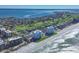 Breathtaking aerial view of beachfront condos, golf course, and expansive ocean views at 1000 Longboat Club Rd # 604, Longboat Key, FL 34228