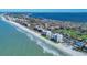 Stunning aerial view of beachfront condos, pristine beach, and rolling ocean waves at 1000 Longboat Club Rd # 604, Longboat Key, FL 34228