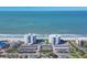 Aerial view showcases the ocean front condos, community pool, tennis court, and private parking in this prime location at 1000 Longboat Club Rd # 604, Longboat Key, FL 34228