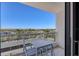 Balcony with table and chairs plus a view of the neighborhood, water, and blue sky at 1000 Longboat Club Rd # 604, Longboat Key, FL 34228