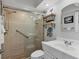Bathroom featuring a glass-enclosed shower, floating shelves, and updated sink and fixtures at 1000 Longboat Club Rd # 604, Longboat Key, FL 34228