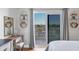 Bedroom featuring sliding glass doors to a private balcony, desk, and decorative shelving at 1000 Longboat Club Rd # 604, Longboat Key, FL 34228