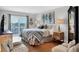 Bedroom with a sliding door leading to an outdoor patio, hardwood floors, and modern decor at 1000 Longboat Club Rd # 604, Longboat Key, FL 34228