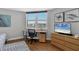 Bright bedroom featuring a window overlooking the city, hardwood floors, and modern decor at 1000 Longboat Club Rd # 604, Longboat Key, FL 34228