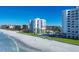 Exterior shot showcasing direct beach access to the white condo building at 1000 Longboat Club Rd # 604, Longboat Key, FL 34228