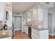 Bright kitchen features white cabinets, stainless steel appliances, and solid surface counters at 1000 Longboat Club Rd # 604, Longboat Key, FL 34228