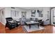A well-lit living room has hardwood floors, modern furniture, and contemporary artwork at 1000 Longboat Club Rd # 604, Longboat Key, FL 34228