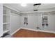 Bright walk-in closet with wooden floors, rod, and shelves for ample storage at 1000 Longboat Club Rd # 604, Longboat Key, FL 34228