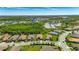 Aerial view of a well-manicured property in a quiet neighborhood near lakes and green spaces at 10510 Giddens Pl, Palmetto, FL 34221