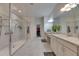 Spacious bathroom featuring double vanities, granite counters, and glass enclosed shower at 10510 Giddens Pl, Palmetto, FL 34221
