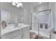 Modern bathroom with glass-enclosed shower, white vanity, and decorative accents, showcasing style and functionality at 10510 Giddens Pl, Palmetto, FL 34221