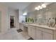 Elegant bathroom featuring double sinks, granite counters, and modern fixtures, creating a luxurious space at 10510 Giddens Pl, Palmetto, FL 34221