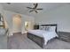 Well-lit bedroom with gray carpet, ceiling fan and an ensuite bath offers a private retreat at 10510 Giddens Pl, Palmetto, FL 34221