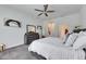 Cozy bedroom featuring a large bed, gray carpet, and a view into an arched doorway at 10510 Giddens Pl, Palmetto, FL 34221