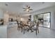 Elegant dining room with wooden table and chairs, connecting to the kitchen and outdoor patio at 10510 Giddens Pl, Palmetto, FL 34221