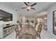 Open-concept dining room with decorative table and chairs with modern cabinets and a view into the spacious kitchen at 10510 Giddens Pl, Palmetto, FL 34221