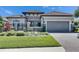 Charming home with a two-car garage, stone accents, and manicured lawn, providing curb appeal at 10510 Giddens Pl, Palmetto, FL 34221