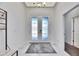 Bright foyer with decorative glass double doors and tiled floor creating an inviting entrance at 10510 Giddens Pl, Palmetto, FL 34221