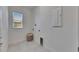 Bright laundry room with a window, white walls, tile floor, and hookups for appliances at 10510 Giddens Pl, Palmetto, FL 34221