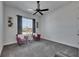 Cozy living room features plush armchairs, a side table, a ceiling fan, and a large window for natural light at 10510 Giddens Pl, Palmetto, FL 34221