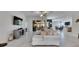 Bright living room with expansive sliding glass doors, neutral tile, and a stylish sectional sofa at 10510 Giddens Pl, Palmetto, FL 34221