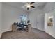 Home office with neutral carpet, ceiling fan, window with blinds, and a desk with computer at 10510 Giddens Pl, Palmetto, FL 34221