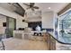 Spacious outdoor kitchen with stainless steel appliances, stone accents, and a granite countertop bar at 10510 Giddens Pl, Palmetto, FL 34221
