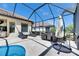 Covered patio featuring lounge chairs and an outdoor dining set for entertaining at 10510 Giddens Pl, Palmetto, FL 34221