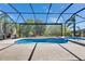 Beautiful screened in pool with a connected spa and neutral colored patio at 10510 Giddens Pl, Palmetto, FL 34221
