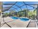 View of the pool and spa under a screened in patio with an outdoor kitchen and dining at 10510 Giddens Pl, Palmetto, FL 34221