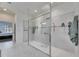 Modern walk-in shower with gray tiling, multiple shower heads, and a glass enclosure at 10510 Giddens Pl, Palmetto, FL 34221
