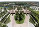 Beautiful aerial view of a grand entrance, featuring manicured landscaping and elegant architecture in a luxurious community at 12091 Amica Loop, Venice, FL 34293