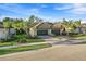 Beautiful home with a three-car garage, lush landscaping, and a stylish tiled roof, enhancing its curb appeal at 12091 Amica Loop, Venice, FL 34293