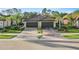 Gorgeous home with a three-car garage, meticulously maintained landscaping, and a stylish paver driveway for curb appeal at 12091 Amica Loop, Venice, FL 34293