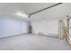 Spacious garage featuring epoxy floor, blue accent wall and an insulated garage door at 12091 Amica Loop, Venice, FL 34293