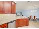 Open kitchen area with granite counters, tile backsplash, and stainless steel appliances at 12091 Amica Loop, Venice, FL 34293
