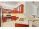 Kitchen featuring stainless steel appliances, granite countertops and wooden cabinetry at 12091 Amica Loop, Venice, FL 34293