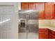 Kitchen featuring stainless steel refrigerator and wooden cabinetry at 12091 Amica Loop, Venice, FL 34293