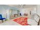 Bright living room with neutral tile, and a statement rug, offering a comfortable and stylish living space at 12091 Amica Loop, Venice, FL 34293