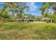 Sprawling backyard with lush lawn, landscaping, and a gazebo for outdoor enjoyment at 1240 Fox Creek Dr, Sarasota, FL 34240