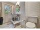 Stylish bathroom with a unique sink, marble floors, subway tile, and a modern toilet at 1240 Fox Creek Dr, Sarasota, FL 34240