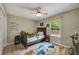 Cozy bedroom with wood floors, comfortable bed, and a playful dinosaur themed area rug at 1240 Fox Creek Dr, Sarasota, FL 34240