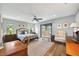 Comfortable bedroom featuring a ceiling fan, a sliding glass door, and natural light from two windows at 1240 Fox Creek Dr, Sarasota, FL 34240