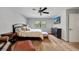 Bright bedroom featuring wood floors, a large window, and updated fixtures with comfortable furniture at 1240 Fox Creek Dr, Sarasota, FL 34240