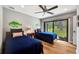 Well-lit bedroom with two twin beds, sliding glass doors to the backyard, and classic hardwood flooring at 1240 Fox Creek Dr, Sarasota, FL 34240