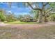 Charming single-story home with a sprawling lawn, mature trees, and a long driveway at 1240 Fox Creek Dr, Sarasota, FL 34240