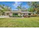 Well-manicured backyard featuring lush green grass, mature shrubs and trees at 1240 Fox Creek Dr, Sarasota, FL 34240