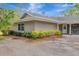 Side of house and garden, featuring neutral siding and well-maintained landscaping at 1240 Fox Creek Dr, Sarasota, FL 34240