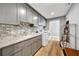 Well-organized laundry room featuring gray cabinets, granite countertop and modern appliances at 1240 Fox Creek Dr, Sarasota, FL 34240